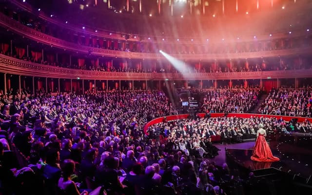 Olivier Awards ceremony inside the Royal Albert Hall in London with a performer on stage and a packed crowd