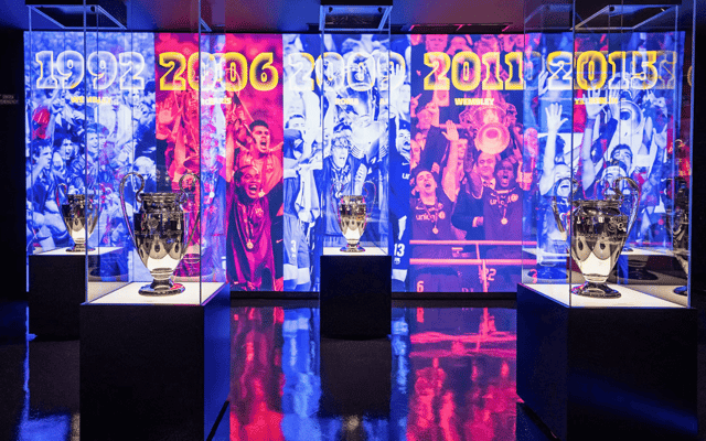 Champions League trophies and backlit history wall at the FC Barcelona Museum
