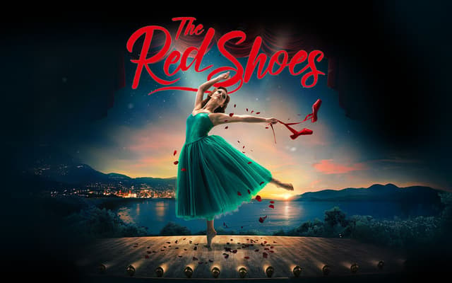 The Red Shoes artwork: a ballerina in a green dress on stage holding red ballet shoes at a coastal sunset