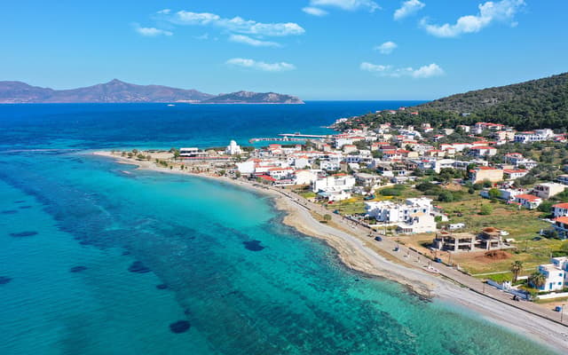 Aerial view of a Greek seaside town with turquoise water on a Saronic island near Athens