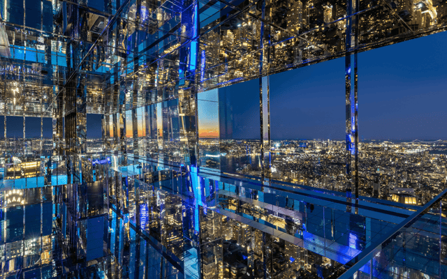 Mirrored glass observation deck at Summit One Vanderbilt reflecting the Manhattan skyline at twilight