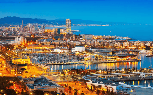 Mediterranean harbour city glowing at dusk with a marina full of boats on the French Riviera
