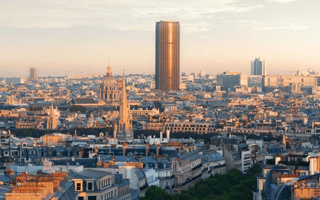 Paris skyline at golden hour with the Montparnasse Tower and the dome of Les Invalides
