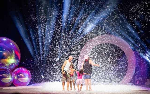 A family on stage surrounded by bubbles at The Gazillion Bubble Show in New York