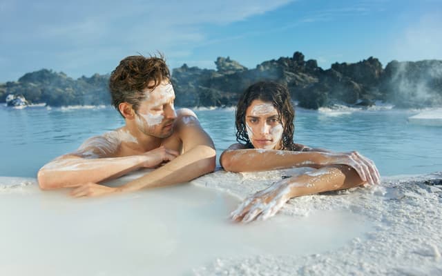Bathers in the milky blue geothermal water of the Blue Lagoon in Iceland
