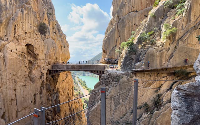 The iconic footbridge of the Caminito del Rey spanning the El Chorro gorge high above the reservoir