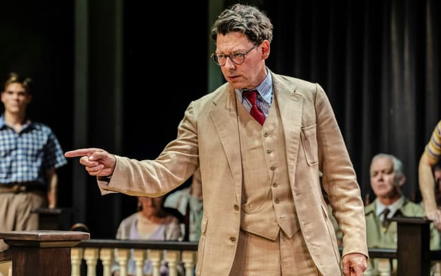 Richard Coyle as Atticus Finch gestures in the courtroom in To Kill a Mockingbird