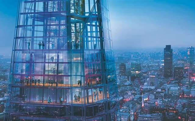 London skyline at golden hour from the Shard with the Thames curving past the City