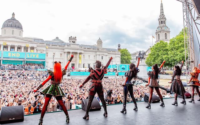 The cast of Six performing on the West End LIVE stage in Trafalgar Square in front of a huge crowd