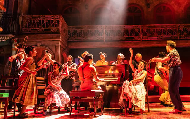 The company of Buena Vista Social Club around the piano on the Gerald Schoenfeld Theatre stage