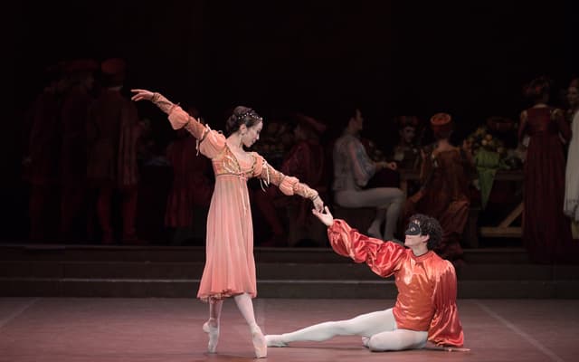 Romeo and Juliet meet at the masked ball in English National Ballet's production at the London Coliseum
