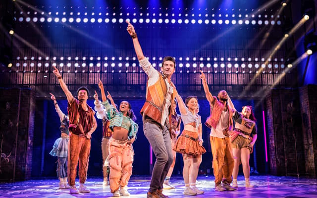 The full cast of & Juliet performing a concert-style number on Broadway