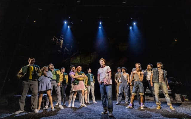The full company of The Outsiders on stage on Broadway