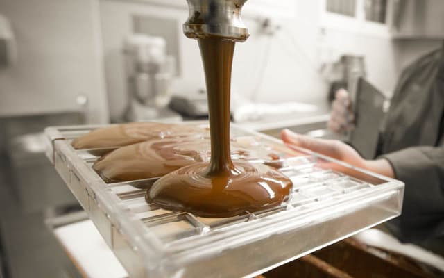 Liquid chocolate being poured into a mould inside an artisan workshop in Venice