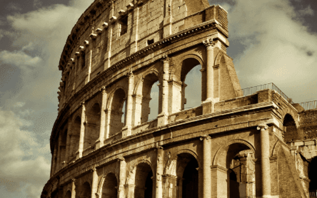 Sepia view of the Colosseum exterior against a cloudy sky in Rome at golden hour