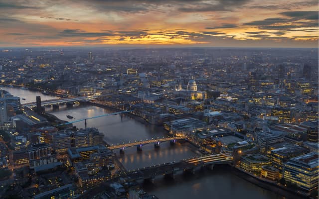 Aerial dusk view of London with the River Thames, lit bridges and St Paul's Cathedral