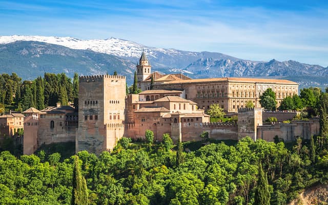 The Alhambra above Granada at golden hour, gateway to Sacromonte's flamenco cave district