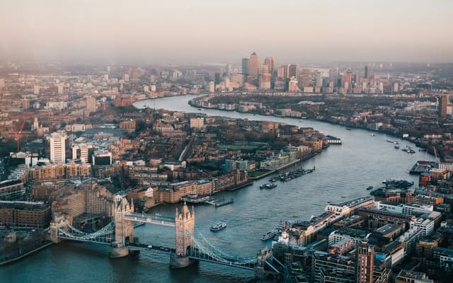 Aerial view of Tower Bridge over the River Thames with the London skyline at dusk
