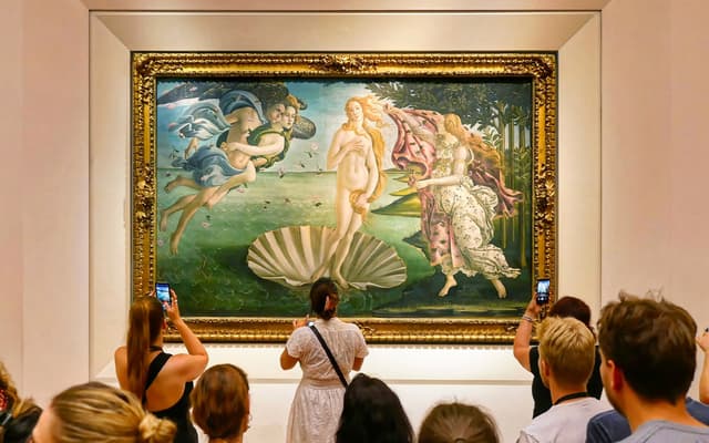 Visitors photographing Botticelli's Birth of Venus at the Uffizi Gallery in Florence
