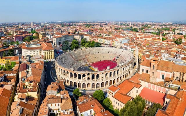 Aerial view of the Verona Arena Roman amphitheatre amid terracotta rooftops in Italy