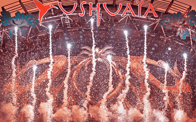 Fireworks erupting over the stage and crowd at Ushuaia open-air club in Ibiza at night