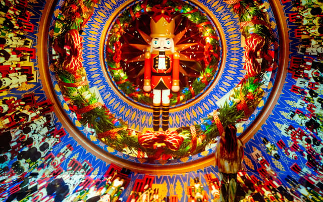 Giant illuminated nutcracker inside a colourful domed Christmas light installation in Houston