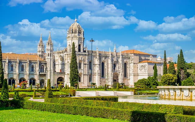 Jeronimos Monastery and gardens under a blue sky in Lisbon
