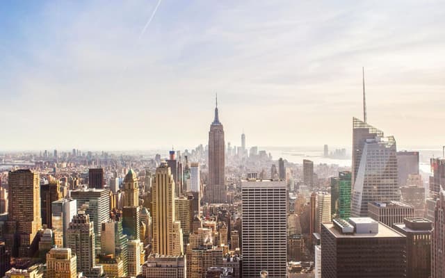New York City skyline from above with the Empire State Building rising over Manhattan