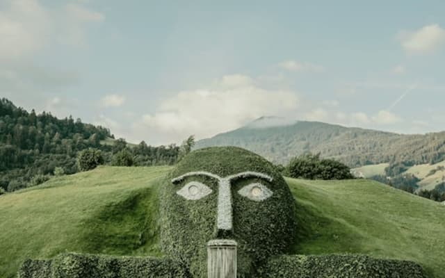 The grass-covered Giant face with crystal eyes at Swarovski Crystal Worlds near Innsbruck