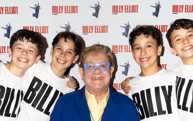 Elton John seated with the four new Billy Elliot actors, Noah Mannion, Rafferty Smale, Spencer Collins and William Gurney