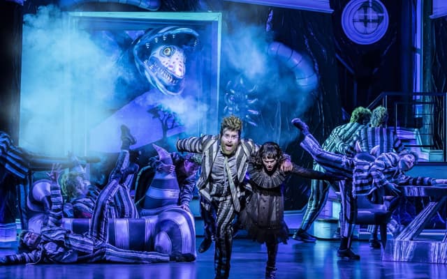 Beetlejuice and the sandworm in the West End production at the Prince Edward Theatre
