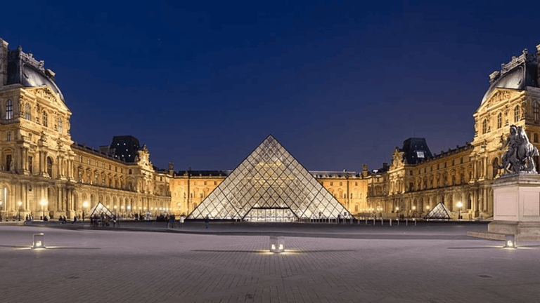 The glass pyramid and historic wings of the Louvre Museum in Paris