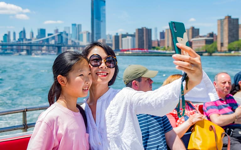 A Circle Line sightseeing cruise on the Hudson with the Manhattan skyline behind