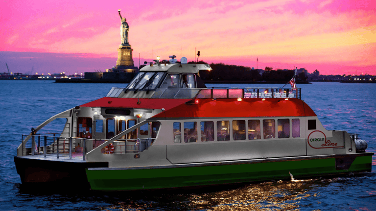 The Statue of Liberty framed against the New York harbour at dusk