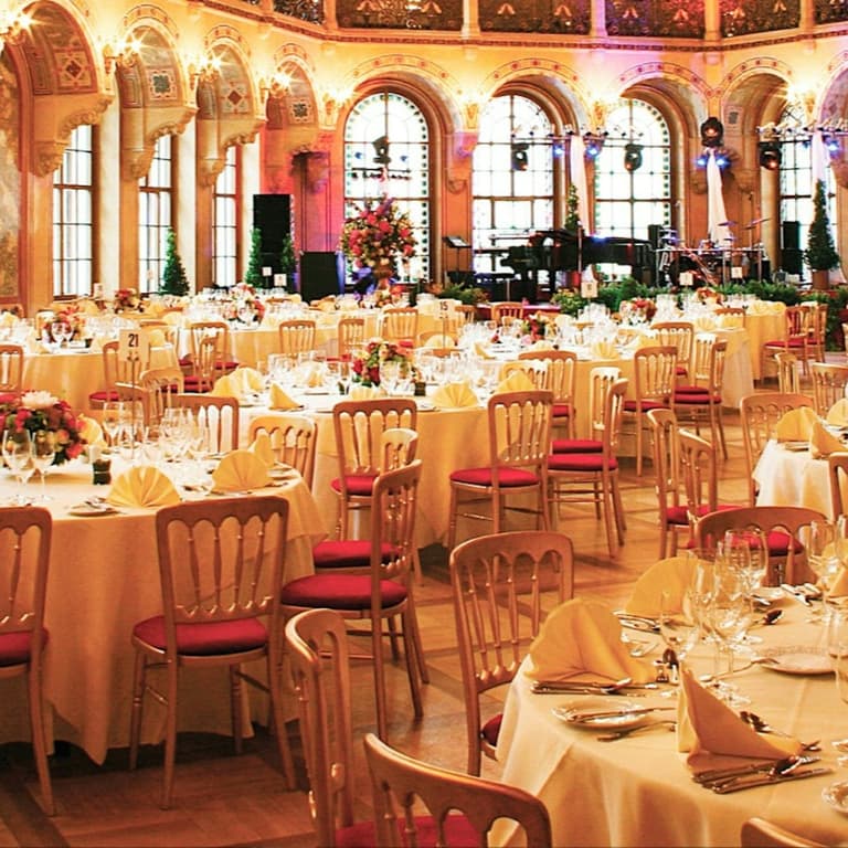 Tables set for the New Year's Eve gala dinner in the grand hall of Palais Ferstel in Vienna
