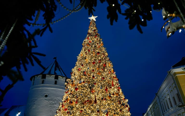 A giant illuminated Christmas tree at night at Walt Disney World