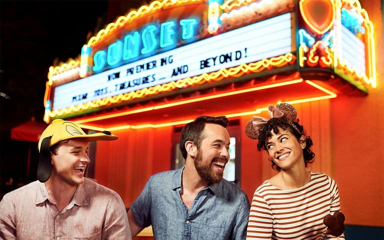 Guests in front of the neon Sunset Boulevard marquee at Disney's Hollywood Studios