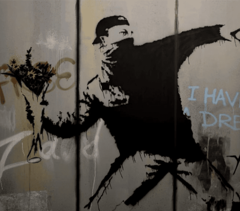 Banksy Flower Thrower stencil street art of a masked figure throwing a bouquet