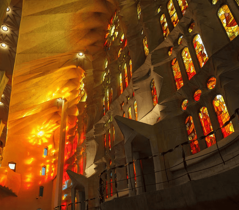 Stained glass windows glowing inside the Sagrada Familia in Barcelona