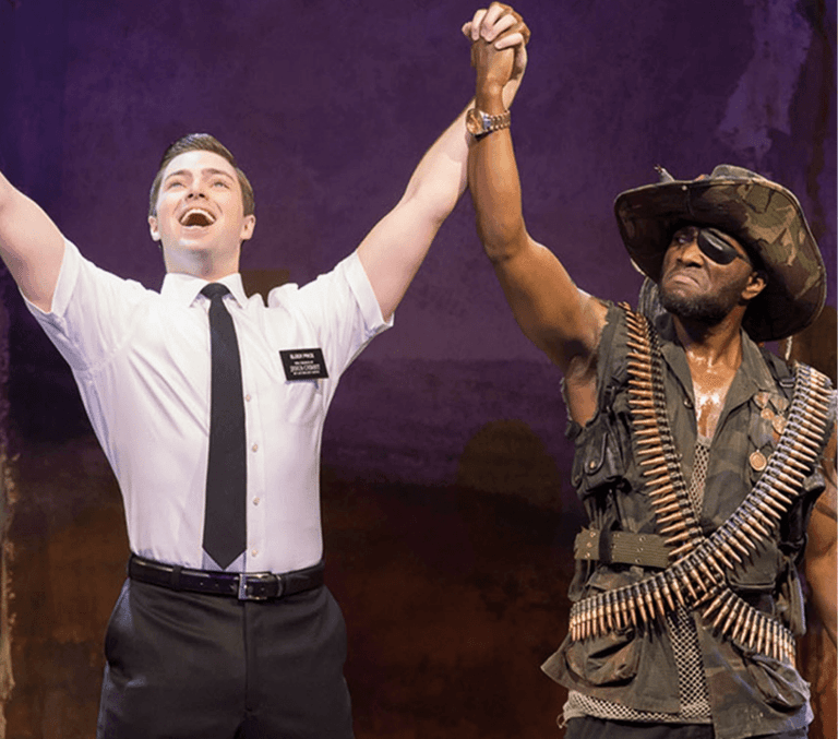 Two missionaries celebrate in The Book of Mormon
