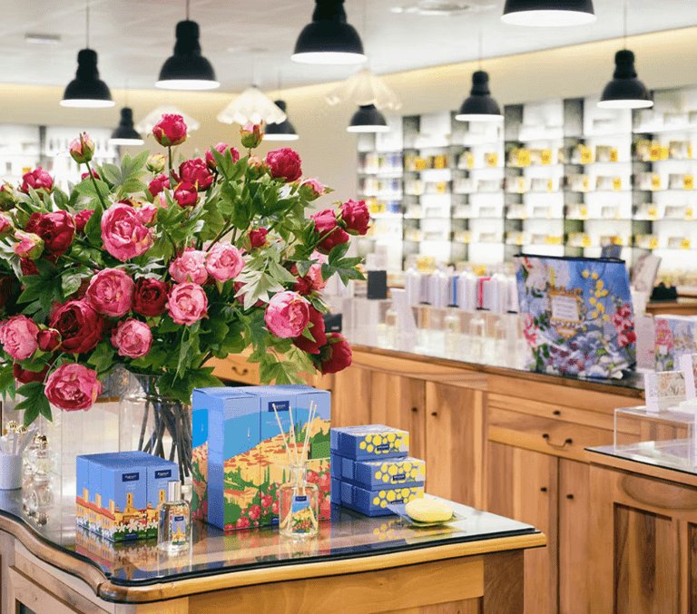 Pink roses and stacked gift boxes in a French Riviera perfume and souvenir boutique