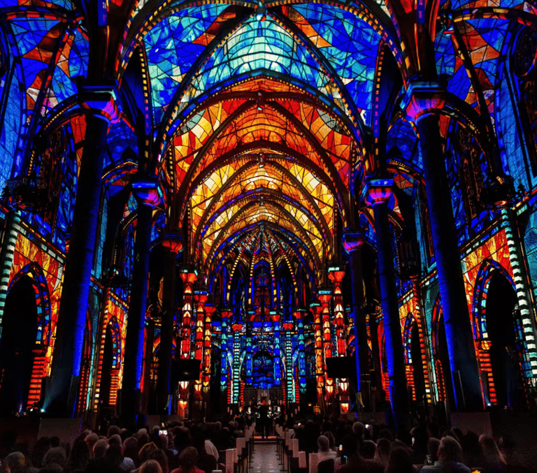 Colourful stained glass light show illuminating a Gothic cathedral interior on the French Riviera