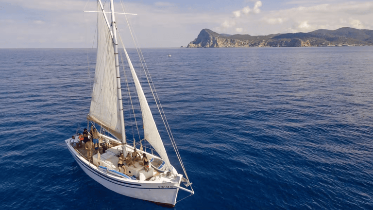 Private sailboat anchored in clear water off the Ibiza coast