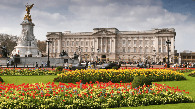 Guards in red tunics and bearskin hats during Changing the Guard at Buckingham Palace