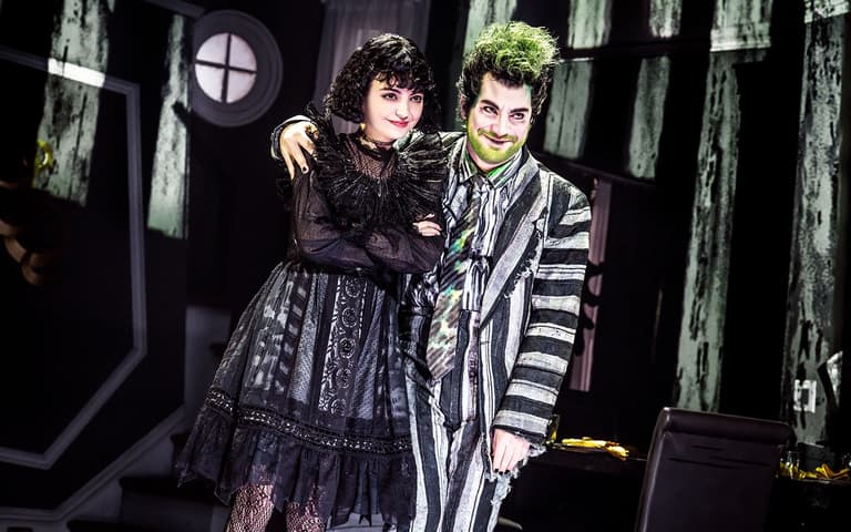 Beetlejuice and Lydia Deetz together on stage in the West End production of Beetlejuice The Musical