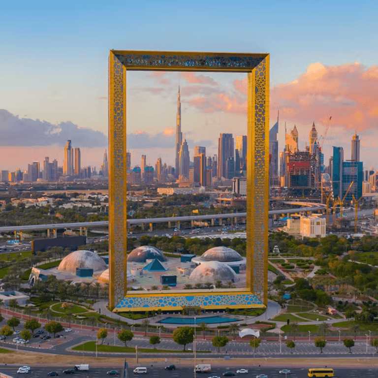 The golden Dubai Frame with the Burj Khalifa and city skyline at sunset