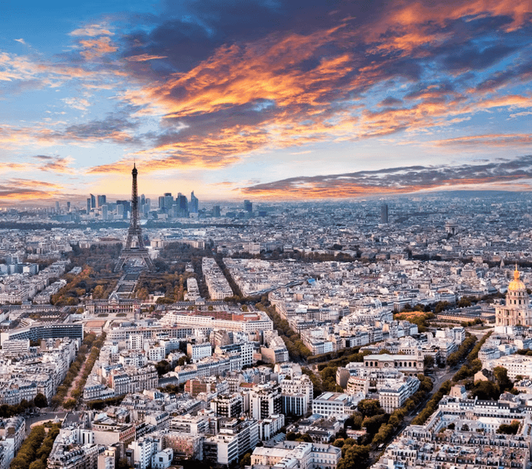 Aerial Paris skyline at sunset with the Eiffel Tower and rooftops