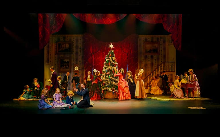 Dancers gathered around a Christmas tree on stage in The Nutcracker at the Tivoli Concert Hall