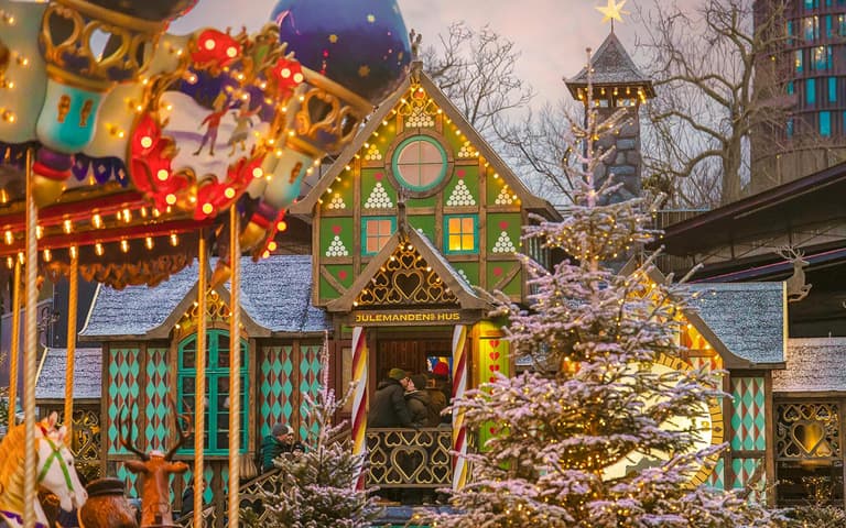 Christmas stalls and decorations lit up at night in Tivoli Gardens