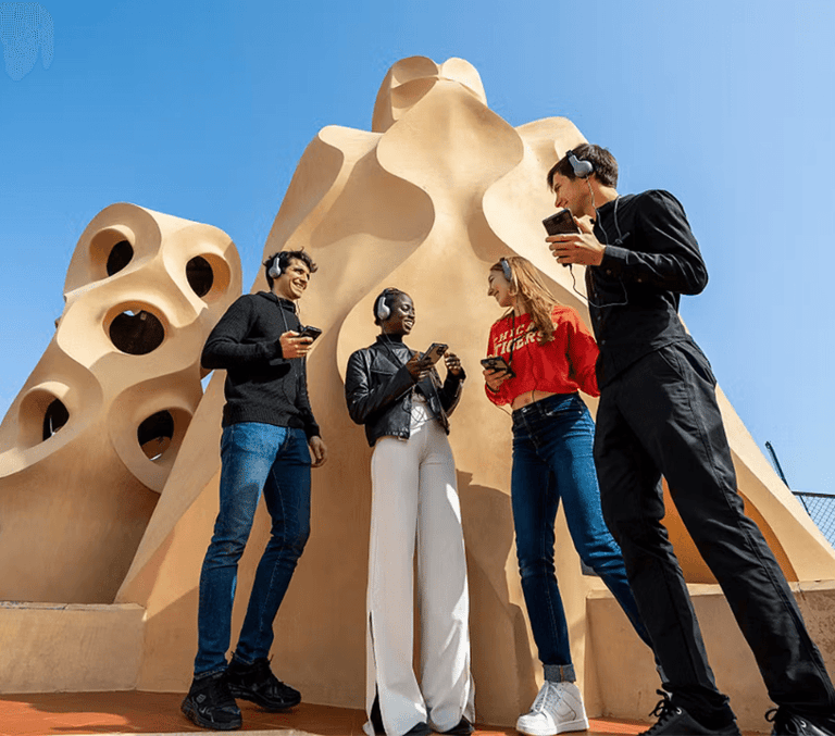 Visitors on Casa Mila La Pedrera rooftop with Gaudi chimneys in Barcelona